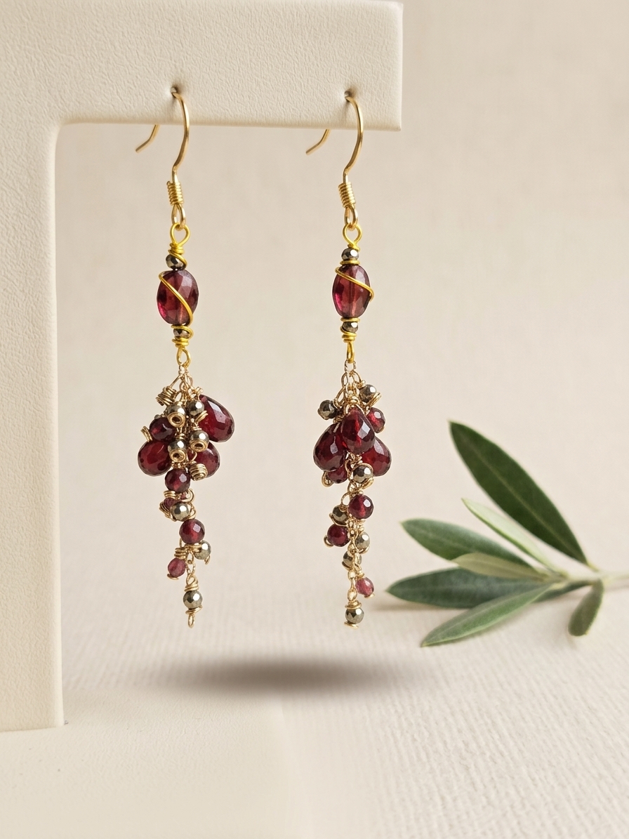 Grapes of Wrath - featuring Faceted Flat Garnet Ovals, Faceted Pyrite Rounds, Faceted Garnet Rounds, Faceted AAA Garnet Briolettes, Gold Plated Brass Chain, Gold Plated Stainless Steel Wire, Gold Plated Copper Wire, Nickel Free Gold Plated Stainless Steel Ear Hooks